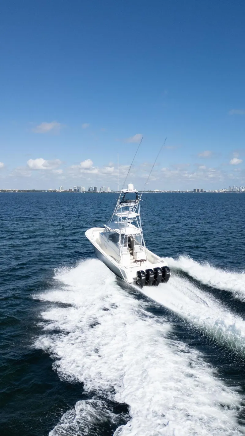 Slide: The Image of 2015 SeaVee 430 Fisharound cruising on open water under clear blue skies. - 34