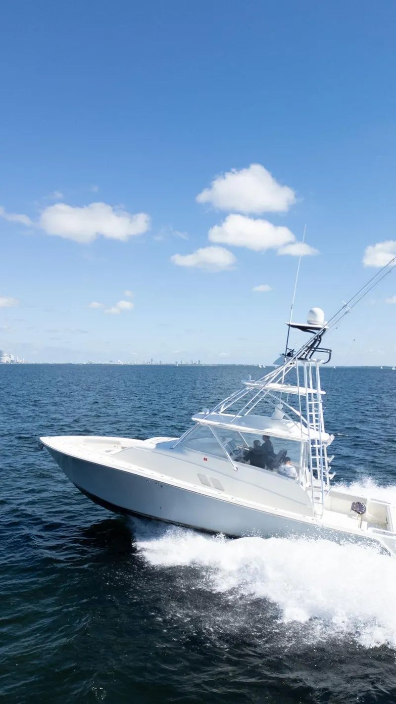 Slide: The Image of 2015 SeaVee 430 Fisharound cruising on open water under a clear blue sky. - 36