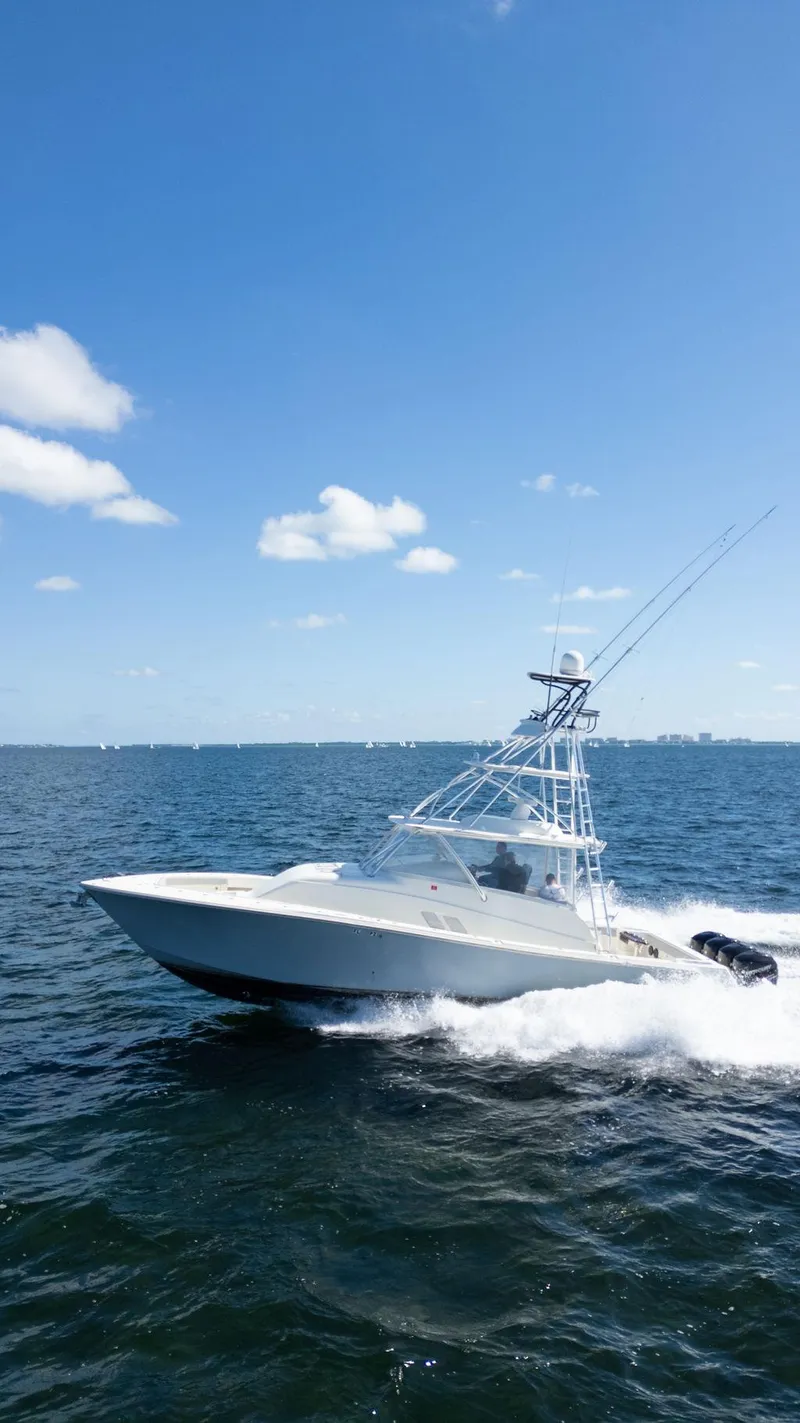 Slide: The Image of 2015 SeaVee 430 Fisharound cruising on open water under a clear blue sky. - 37