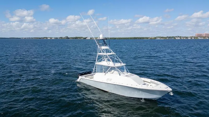 Slide: The Image of 2015 SeaVee 430 Fisharound boat on open water under blue sky. - 4