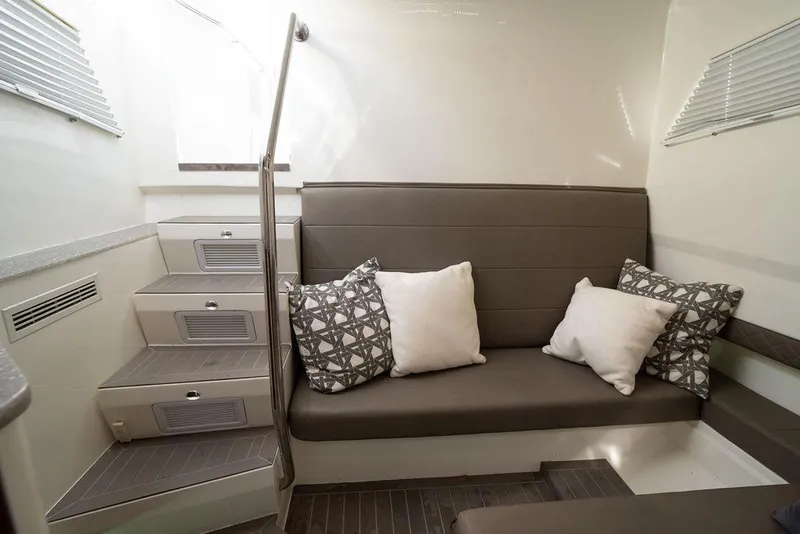 Slide: The Image of Interior of 2015 SeaVee 430 Fisharound with cushioned seating and decorative pillows. - 44