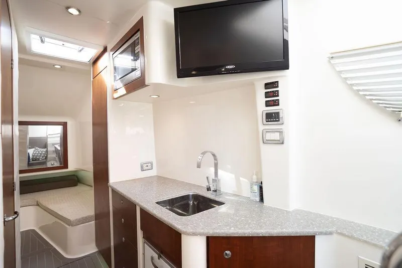 Slide: The Image of 2015 SeaVee 430 Fisharound interior with kitchenette, sink, and TV. - 46