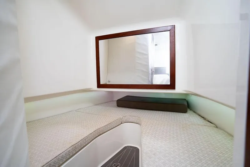 Slide: The Image of 2015 SeaVee 430 Fisharound cabin interior with bed and mirror. - 47