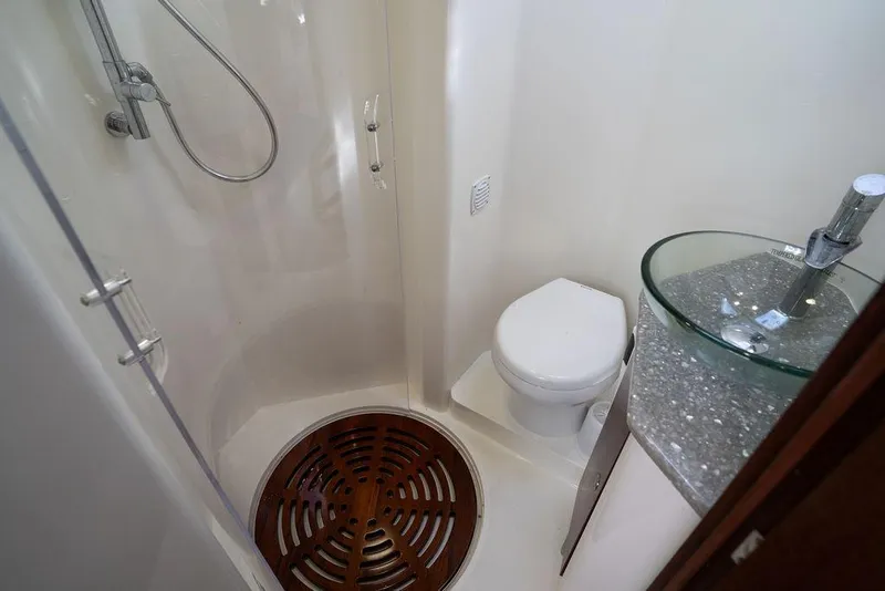 Slide: The Image of Bathroom interior of 2015 SeaVee 430 Fisharound with shower, toilet, and glass sink. - 48
