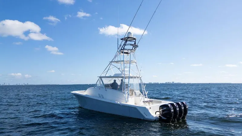 Slide: The Image of 2015 SeaVee 430 Fisharound boat on open water under clear blue sky. - 6
