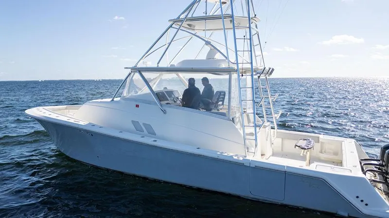 Slide: The Image of 2015 SeaVee 430 Fisharound boat cruising on open water under clear skies. - 7