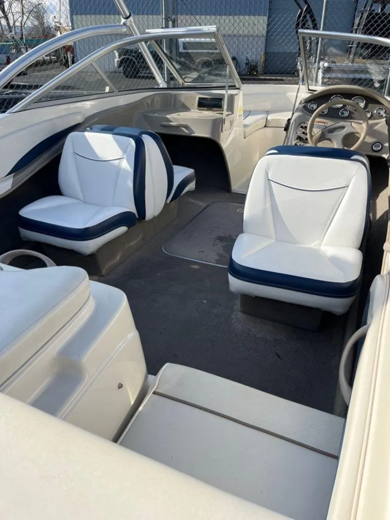 Slide: The Image of Interior of a 2002 Bayliner 185 boat with white and blue seating. - 4