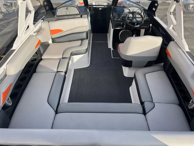 Slide: The Image of 2016 Axis Boats A22 interior with spacious seating and modern dashboard. - 16