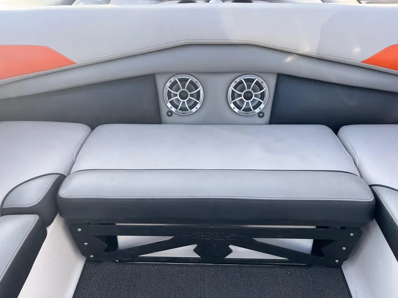 Slide: The Image of 2016 Axis Boats A22 interior seating with dual speakers and cushioned seats. - 20