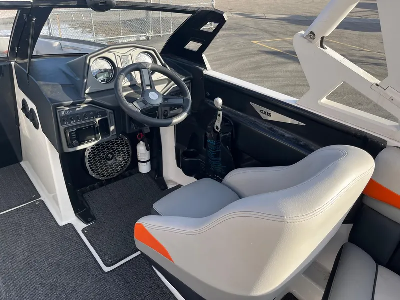Slide: The Image of 2016 Axis Boats A22 interior with steering wheel, dashboard, and seating. - 24