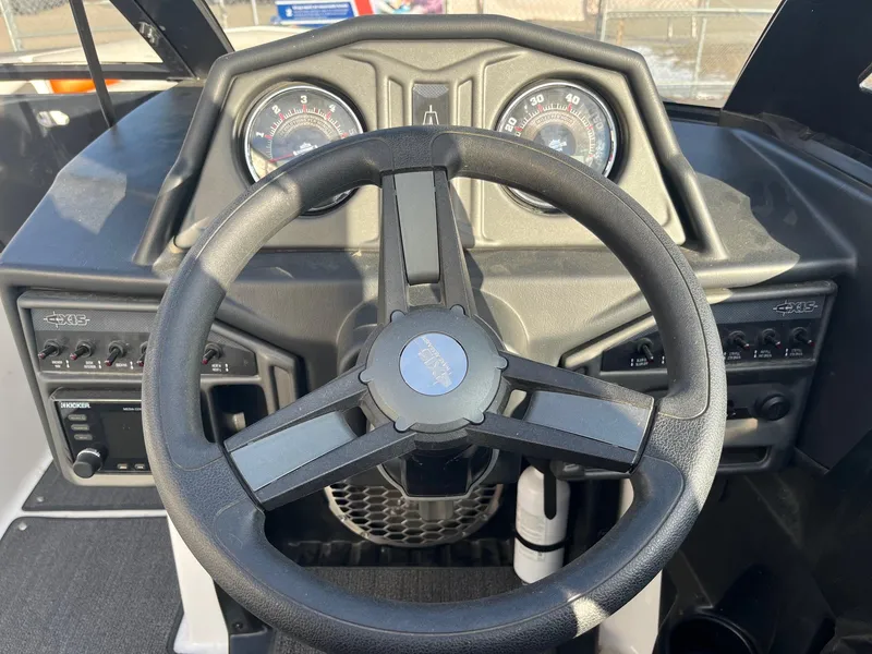 Slide: The Image of 2016 Axis Boats A22 dashboard with steering wheel and gauges. - 26