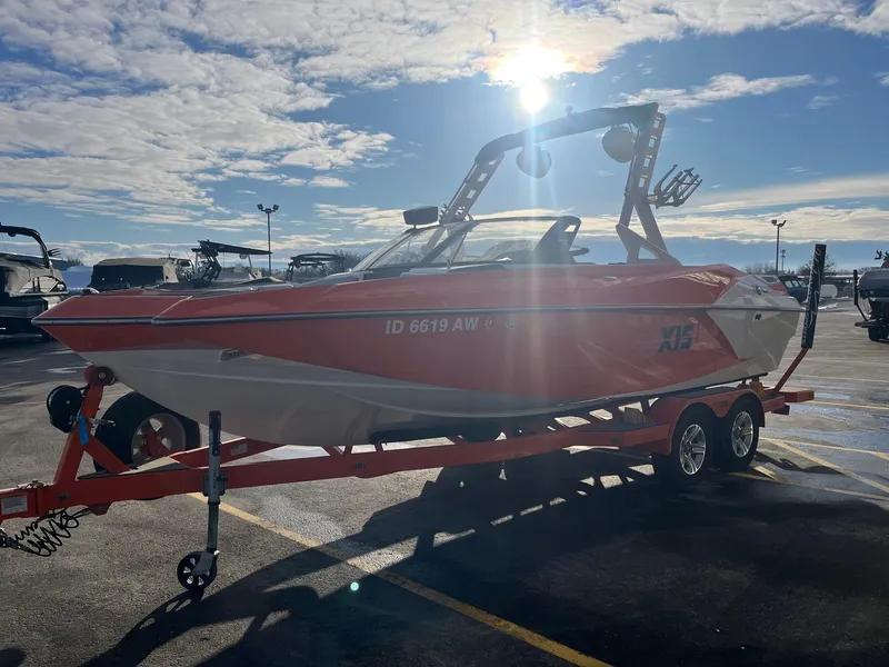 Slide: The Image of 2016 Axis A22 boat with a red and white design, parked on a trailer. - 9
