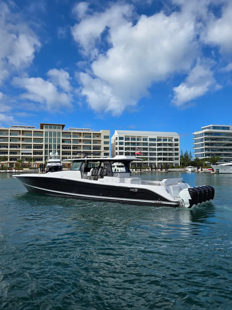 Slide: The Image of 2021 HCB 65 Estrella boat on water with modern buildings in background. - 12