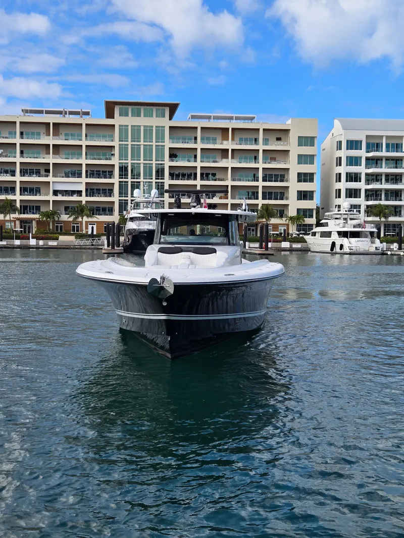 Slide: The Image of 2021 HCB 65 Estrella yacht docked in marina, modern buildings in background. - 17