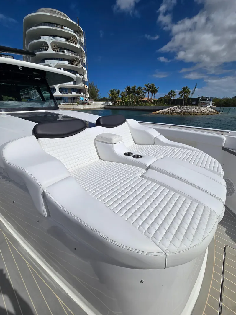 Slide: The Image of Luxurious seating on 2021 HCB 65 Estrella yacht, with modern architecture in the background. - 20