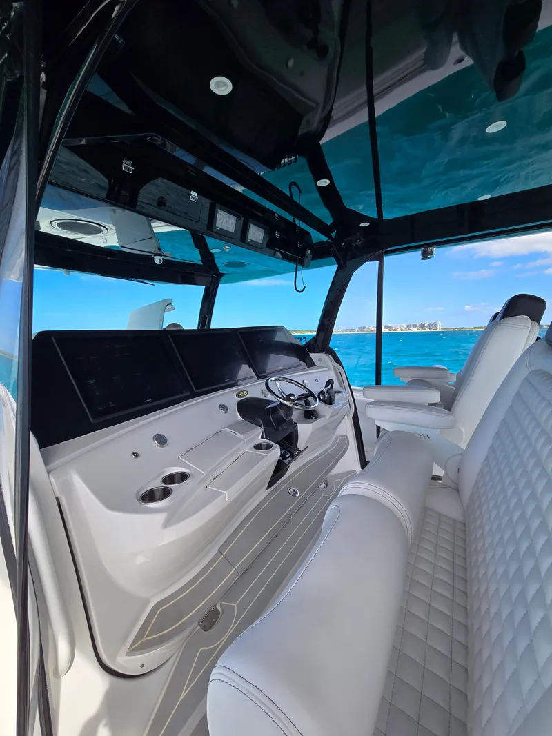 Slide: The Image of Interior of 2021 HCB 65 Estrella boat with luxurious seating and modern dashboard. - 21