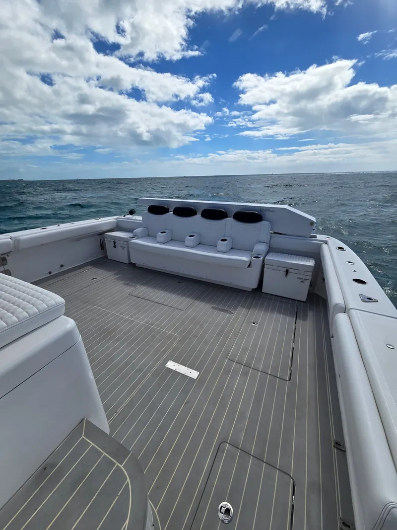 Slide: The Image of 2021 HCB 65 Estrella boat deck with seating, ocean view, and cloudy sky. - 25
