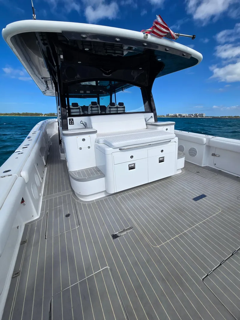 Slide: The Image of 2021 HCB 65 Estrella boat deck with seating, under a clear blue sky. - 26