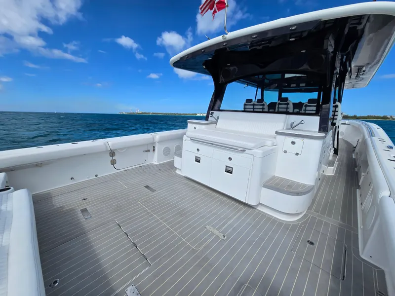 Slide: The Image of 2021 HCB 65 Estrella boat deck with seating, ocean view, and clear blue sky. - 27