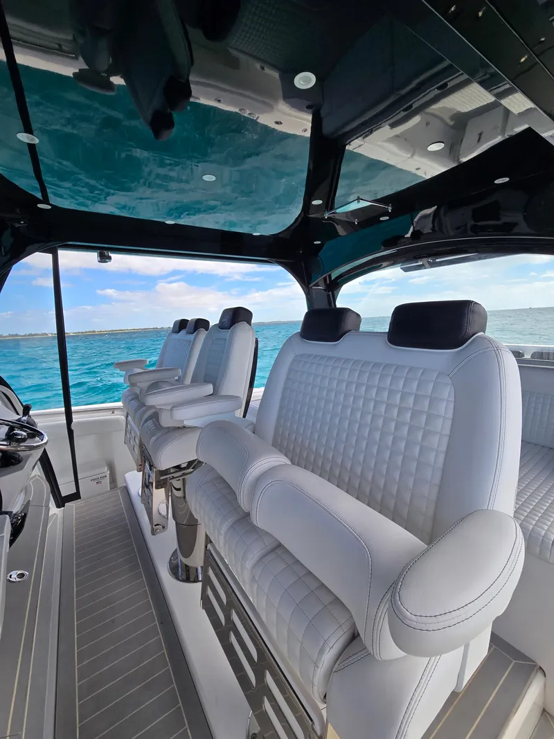 Slide: The Image of Interior of 2021 HCB 65 Estrella boat with luxurious white seating. - 3