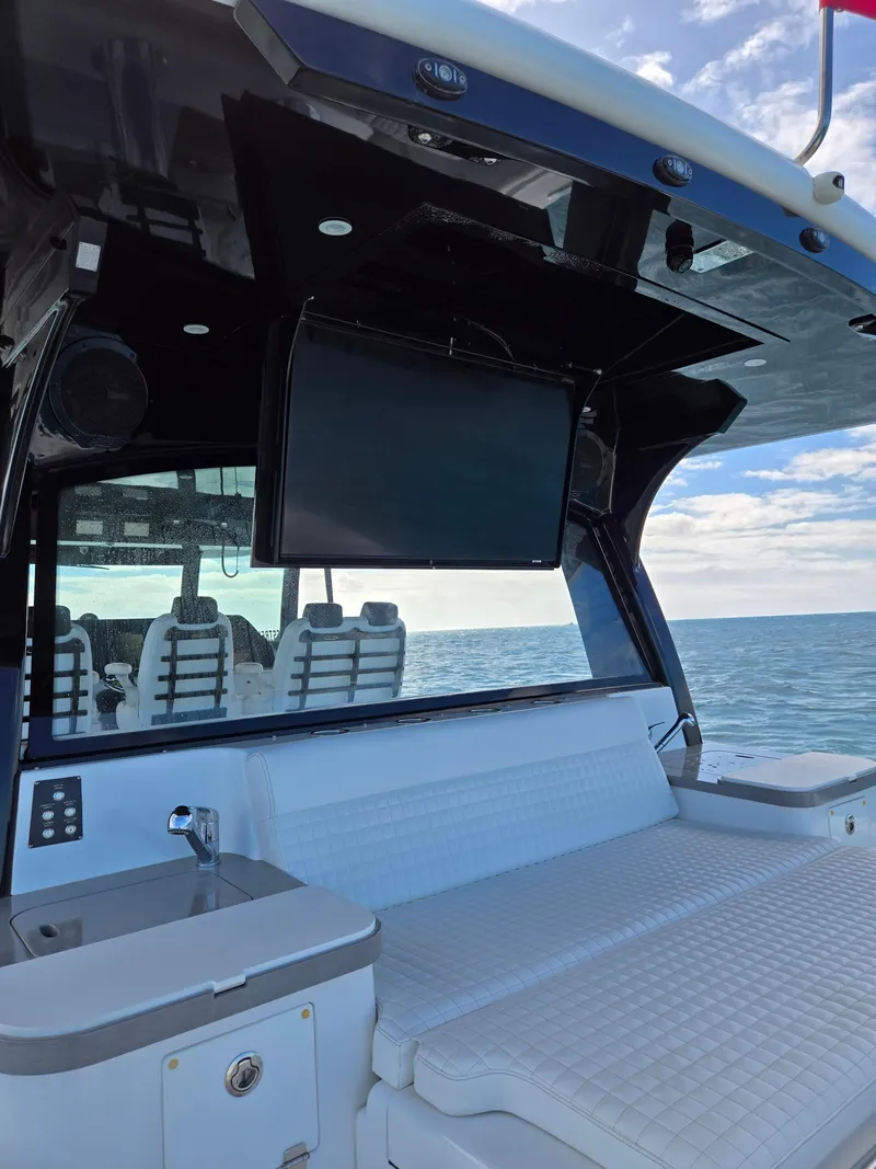 Slide: The Image of 2021 HCB 65 Estrella yacht interior with seating, TV, and ocean view. - 33