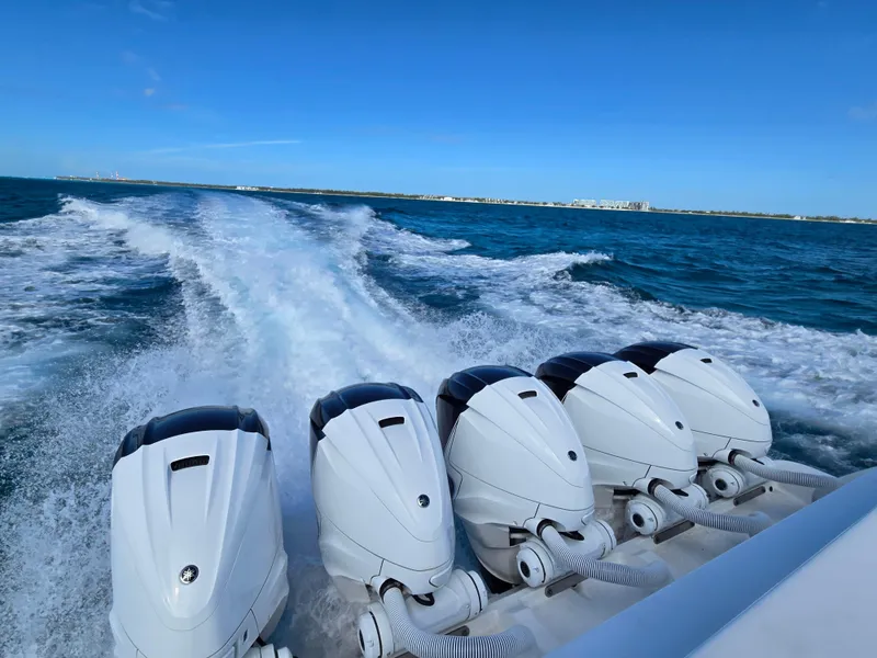 Slide: The Image of 2021 HCB 65 Estrella boat with five powerful outboard engines cruising on open water. - 36