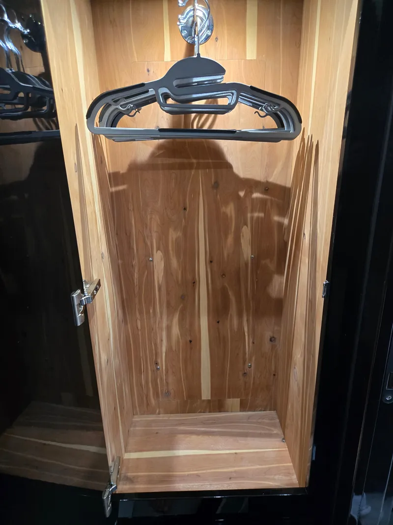 Slide: The Image of Wooden closet interior with hangers, part of a 2021 HCB 65 Estrella model. - 38
