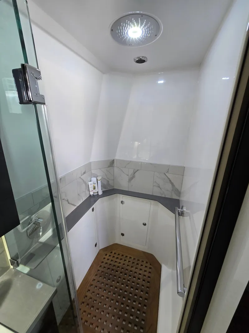 Slide: The Image of Luxurious shower in 2021 HCB 65 Estrella yacht with modern fixtures and wooden floor. - 41