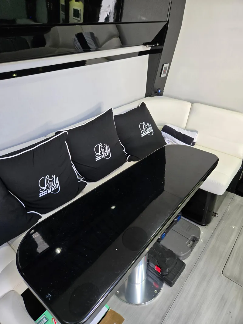 Slide: The Image of Luxurious interior of 2021 HCB 65 Estrella with sleek black table and custom cushions. - 47