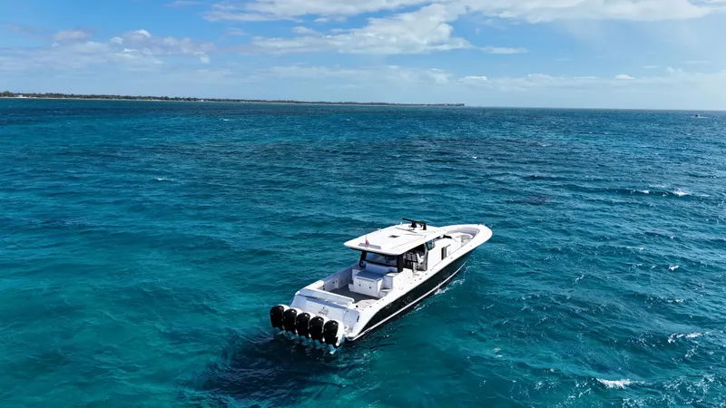 Slide: The Image of 2021 HCB 65 Estrella boat cruising on clear blue ocean waters. - 49