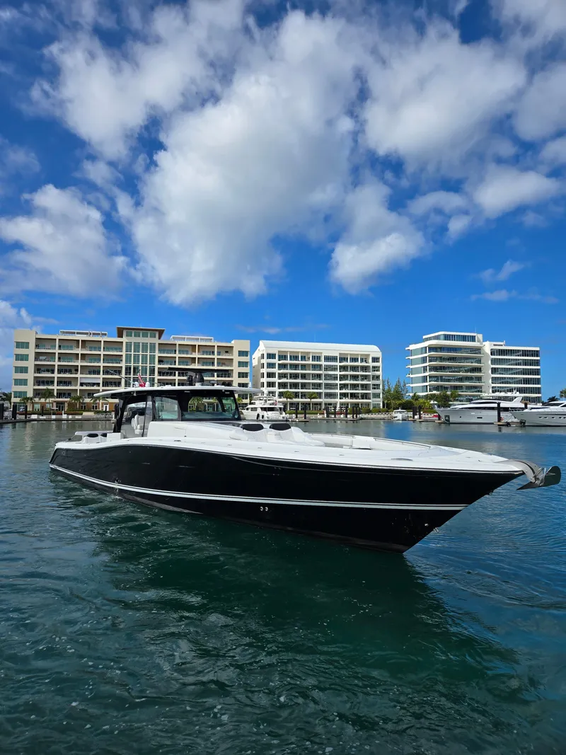 Slide: The Image of 2021 HCB 65 Estrella yacht in marina with modern buildings and blue sky. - 5