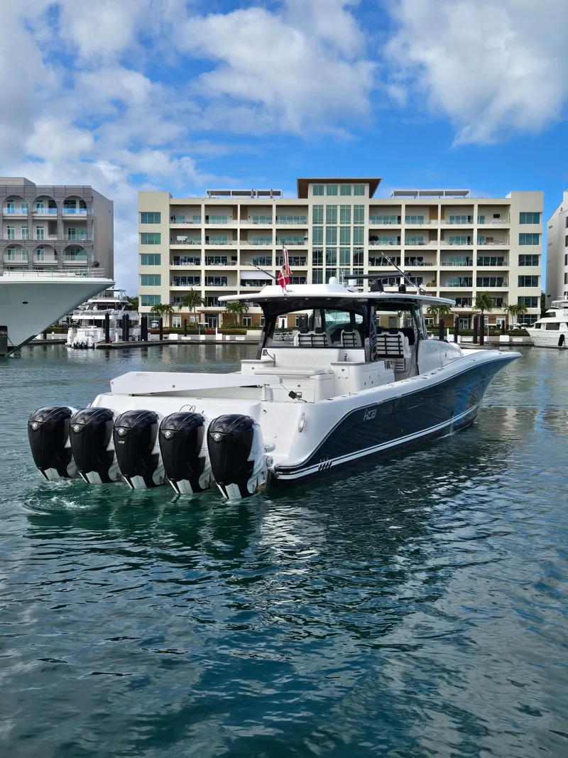 Slide: The Image of 2021 HCB 65 Estrella boat with five engines docked in a marina. - 7