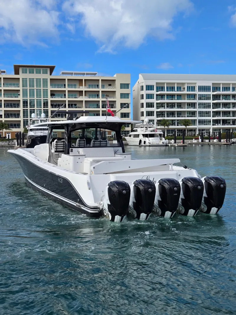 Slide: The Image of 2021 HCB 65 Estrella boat with multiple engines in a marina setting. - 9