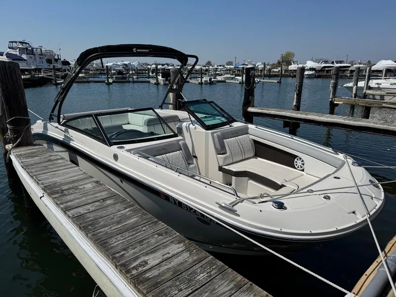Slide: The Image of 2016 Sea Ray SDX 270 boat docked at marina, featuring sleek design and spacious seating. - 2