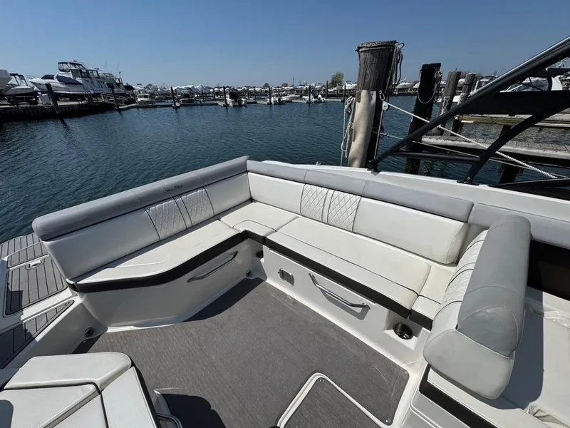 Slide: The Image of 2016 Sea Ray SDX 270 boat with spacious seating, docked at a marina. - 21