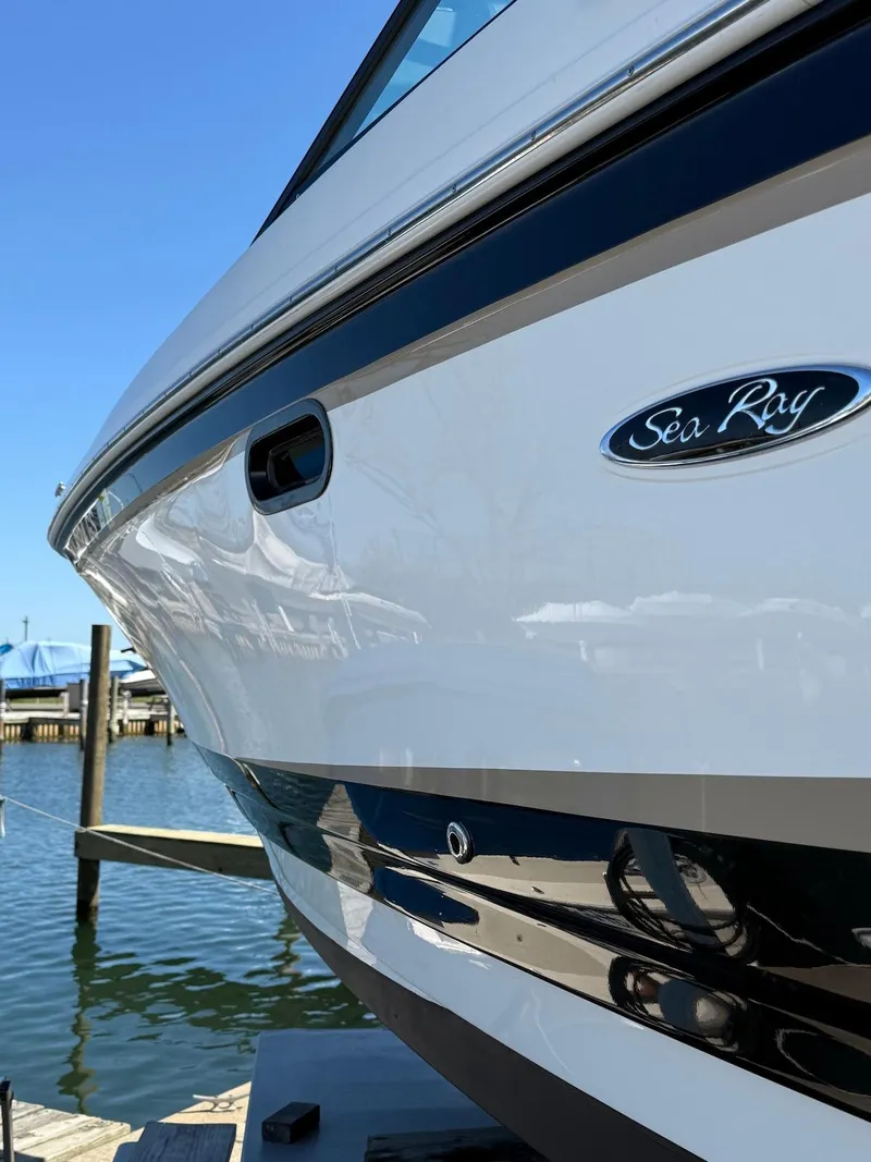 Slide: The Image of 2016 Sea Ray SDX 270 boat docked by the water on a sunny day. - 25