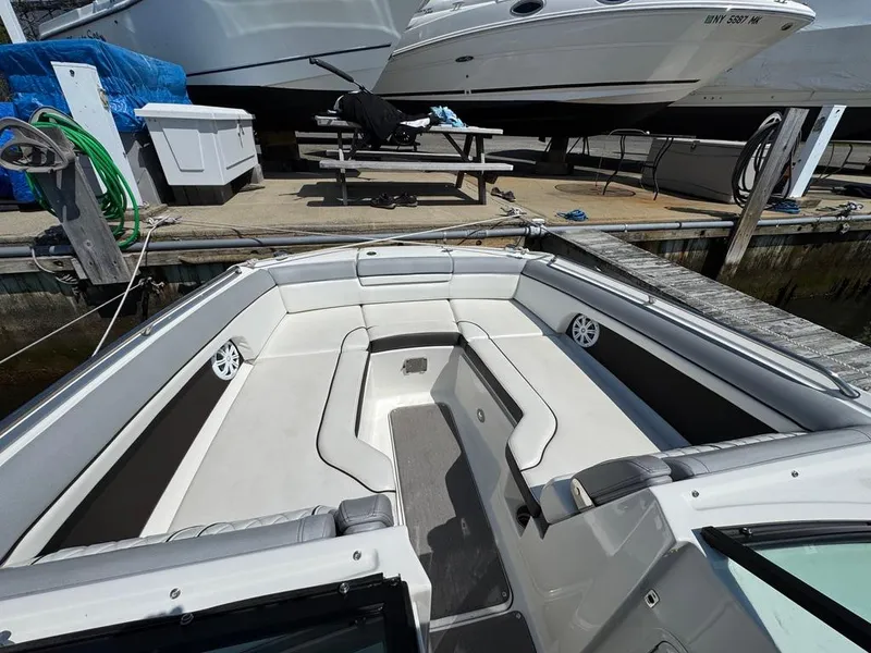 Slide: The Image of 2016 Sea Ray SDX 270 boat interior with spacious seating at a dock. - 5