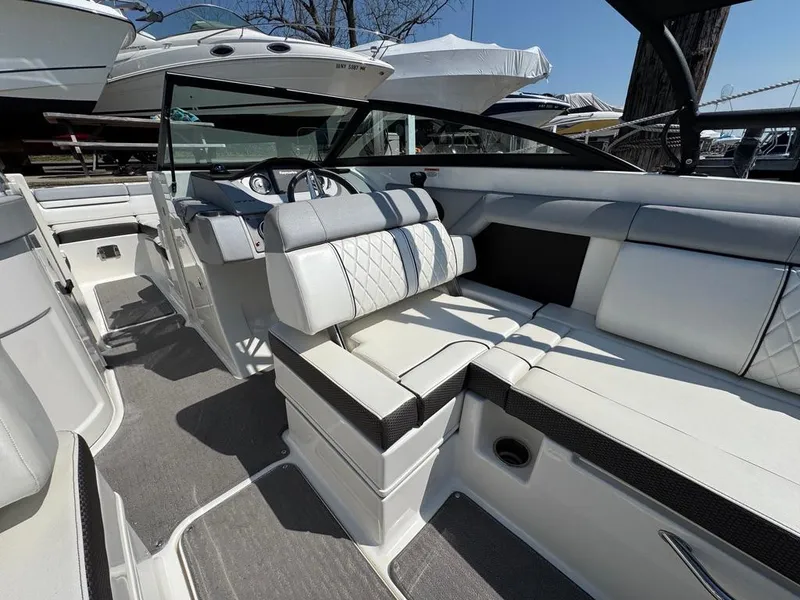 Slide: The Image of 2016 Sea Ray SDX 270 boat interior with white seating and modern dashboard. - 6