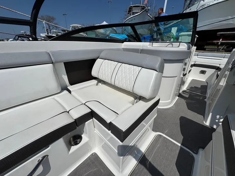 Slide: The Image of 2016 Sea Ray SDX 270 boat interior with white seating and modern design. - 9