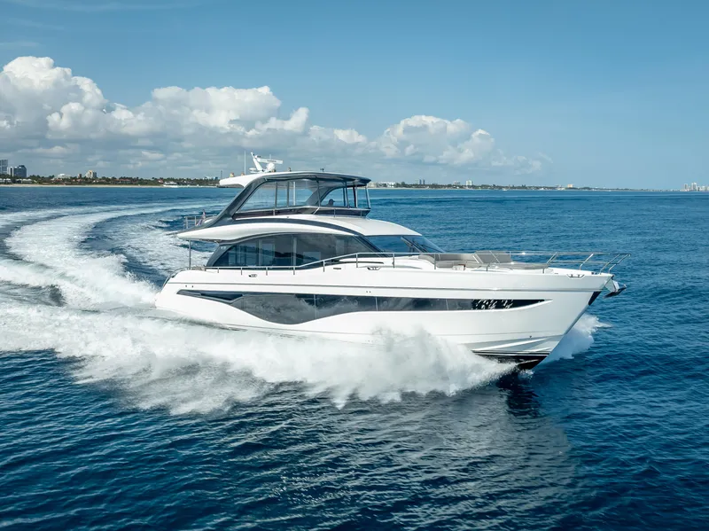 Slide: The Image of 2023 Princess Y72 yacht cruising on open sea under clear skies. - 0