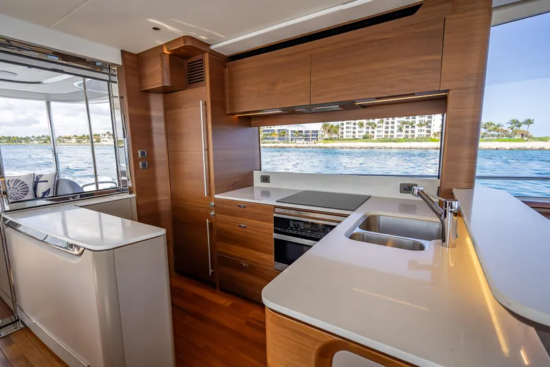 Slide: The Image of Luxurious kitchen interior of 2023 Princess Y72 yacht with modern wood cabinetry and ocean view. - 25