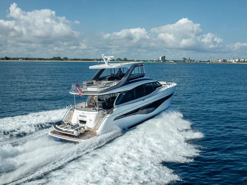 Slide: The Image of 2023 Princess Y72 yacht cruising on open water under a clear blue sky. - 5