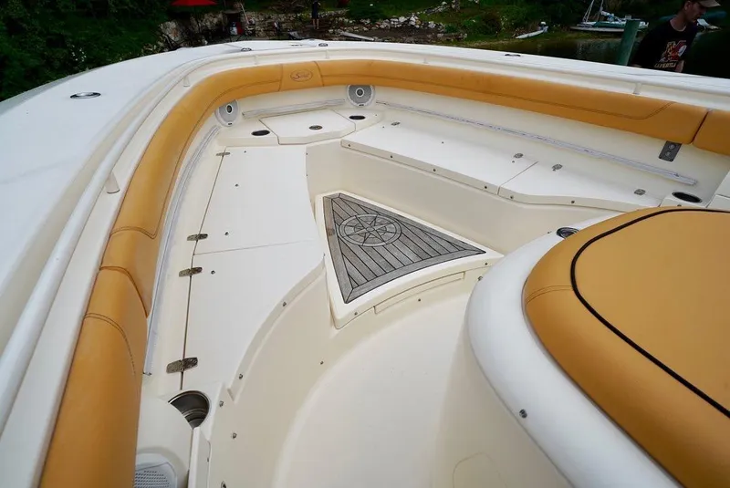 Slide: The Image of 2016 Scout 350 LXF boat interior with tan seating and spacious deck. - 10