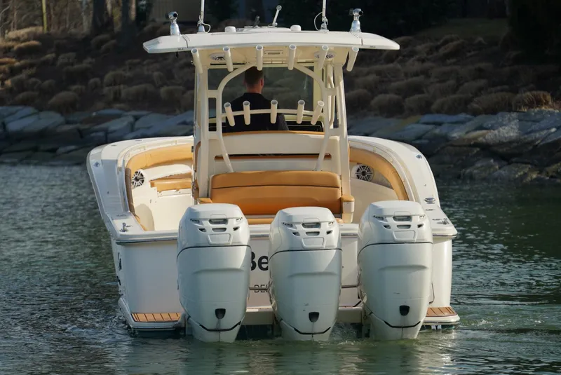Slide: The Image of 2016 Scout 350 LXF boat with triple outboard engines on water. - 13