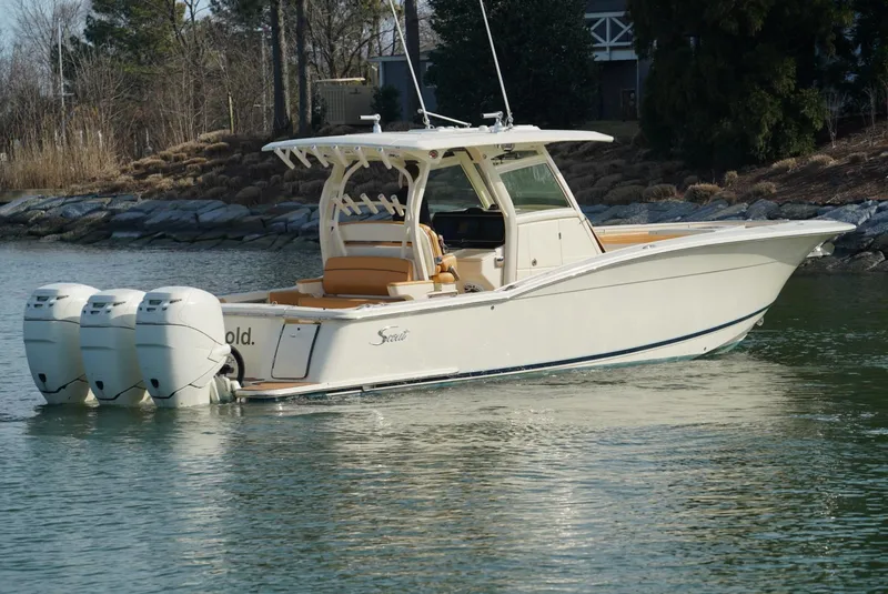 Slide: The Image of 2016 Scout 350 LXF boat with triple engines on a calm lake. - 14