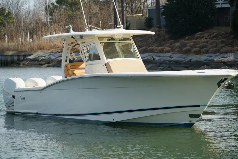 Slide: The Image of 2016 Scout 350 LXF boat on calm water, showcasing sleek design and luxury features. - 15