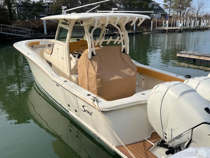 Slide: The Image of 2016 Scout 350 LXF boat docked in a marina, featuring twin outboard engines. - 25