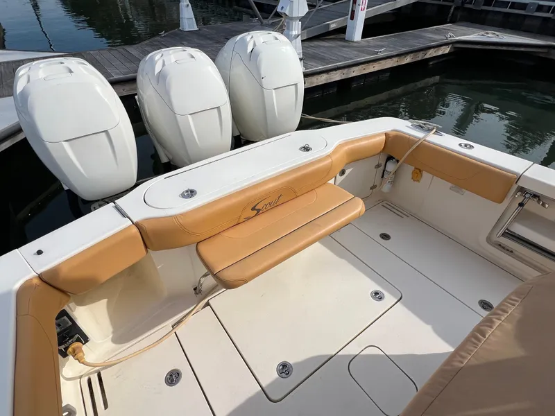Slide: The Image of 2016 Scout 350 LXF boat with triple outboard engines and tan seating. - 28