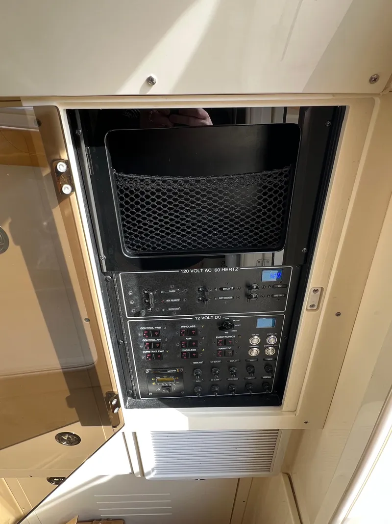 Slide: The Image of Electrical panel inside 2016 Scout 350 LXF boat, featuring various switches and controls. - 32