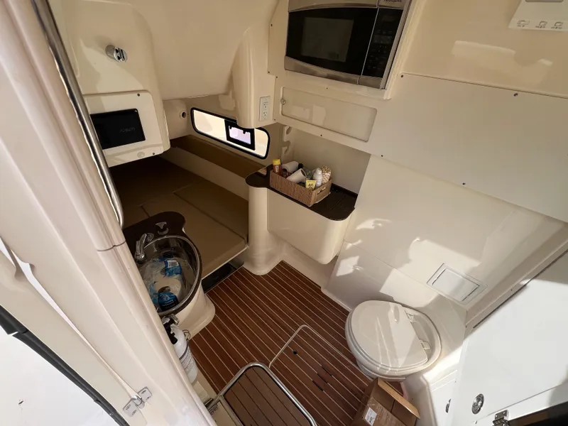 Slide: The Image of 2016 Scout 350 LXF cabin interior with wood flooring, sink, and microwave. - 37